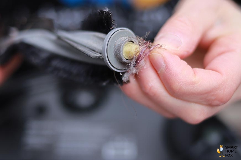 You can see hair wrapped around the brush of the Ecovacs Deebot X1 OMNI.